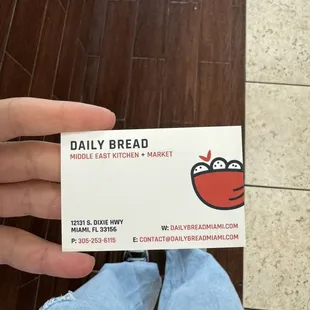 a person holding a business card