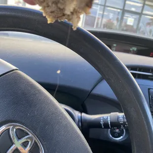 Banana muffin with hair hanging out of it.