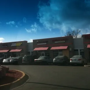 cars parked in front of a restaurant