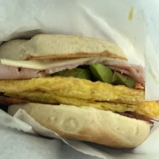 Ham, bacon, cheese, egg, bagel sandwich, add avocado