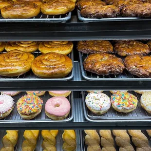 a variety of donuts in a display case