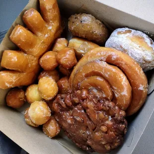 Bear claw, blueberry cake donut, raspberry filled, maple custard-filled bar, cinnamon roll, apple fritter, donut holes