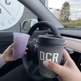 a hand holding a cup of coffee