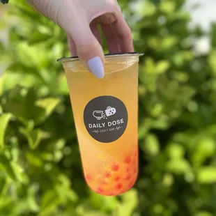 Peach Limeade with strawberry popping boba