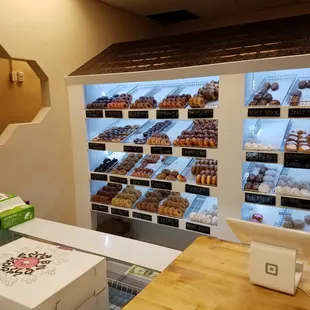a woman at a counter in a donut shop