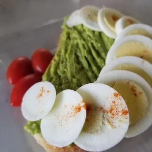 Avocado, egg,  tomato toast,  needs salt