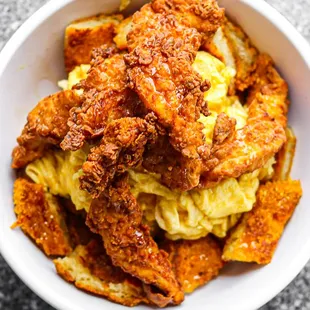 Fluffy scrambled eggs on top of our Chef's famous Cap'N Crunch© french toast; topped with our handmade buttermilk chicken tenders