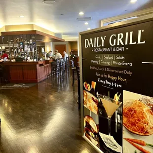Daily Grill sign and bar menu