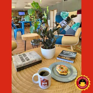 a coffee cup and a donut on a table