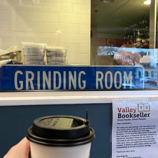 a hand holding a cup of coffee