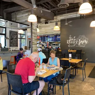 people sitting at tables in a restaurant