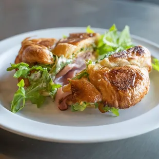 a croissant sandwich on a plate