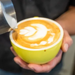 a latte being poured into a cup