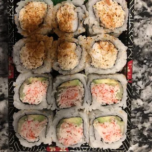 a tray of sushi and rolls