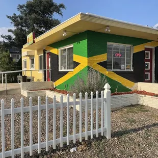 a man standing in front of a painted house