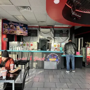 a man sitting at a table in a fast food restaurant