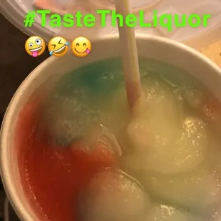 a bowl of liquid with a straw sticking out of it