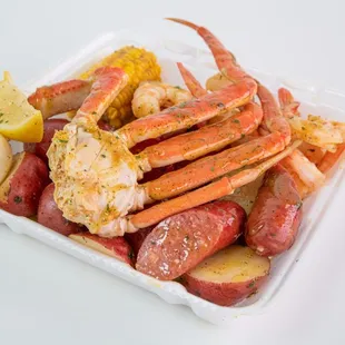 crab legs, potatoes and corn