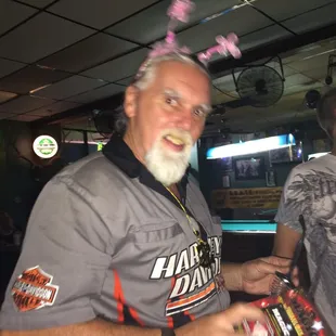 a man with pink hair and a beard