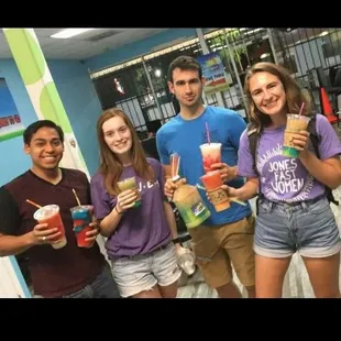 a group of people holding drinks