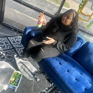 a woman sitting on a blue couch