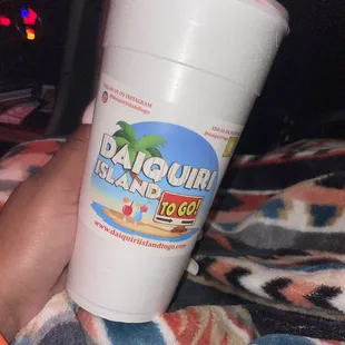 a hand holding a plastic cup