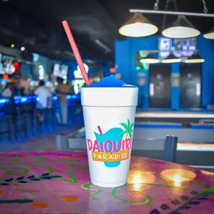 a drink in a plastic cup with a straw