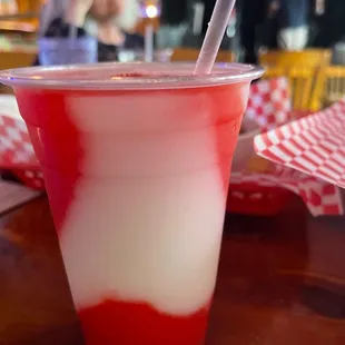 a red and white drink with a straw