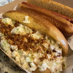 two hot dogs with coleslaw and mustard