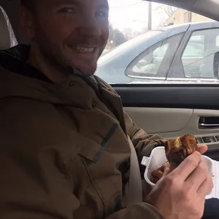 Husband enjoying his breakfast sandwich