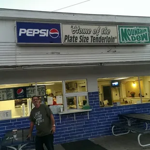 a man standing in front of a dairy bar