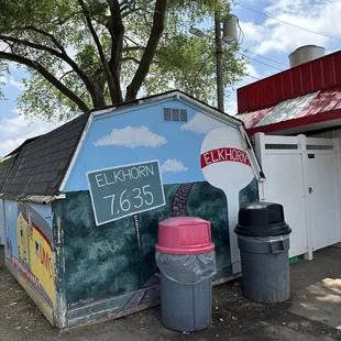 a small building with a sign painted on it