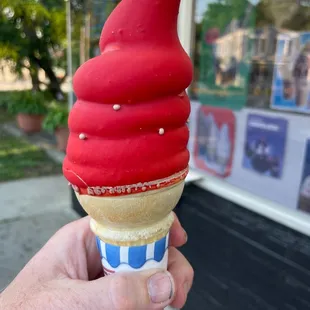 a hand holding an ice cream cone
