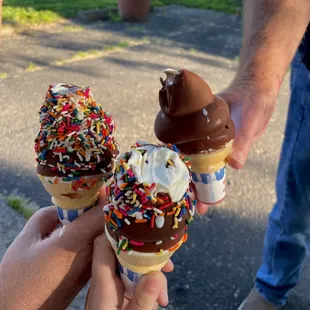 two ice cream cones with chocolate and sprinkles