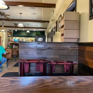 a woman sitting at a table in a restaurant