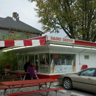 a woman sitting at a picnic table