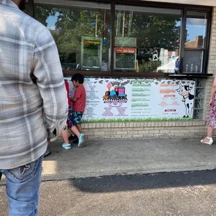 people standing in front of a dairy store