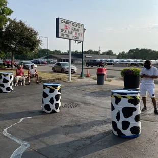 a cow print buckets in a parking lot