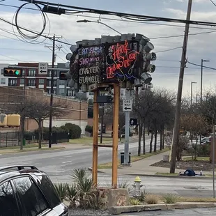 a neon sign in a parking lot