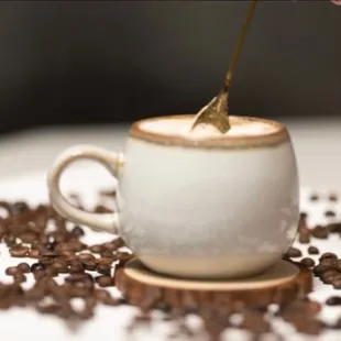 a cup of coffee with a spoon sticking out of it