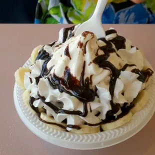 an ice cream sundae topped with whipped cream and chocolate