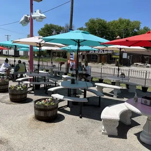 tables and umbrellas in a parking lot