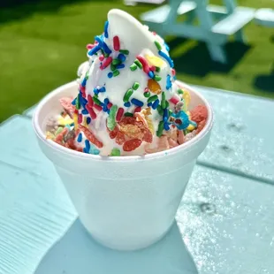 a cup of ice cream with sprinkles