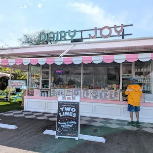 a man and a woman standing in front of a candy shop