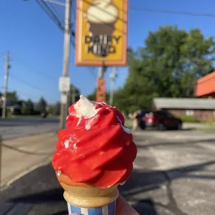 a hand holding an ice cream cone
