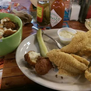 5 piece catfish dinner with a bowl of brown beans instead of fries.