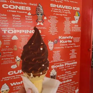 a hand holding an ice cream cone