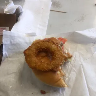 a sandwich with onion rings on it