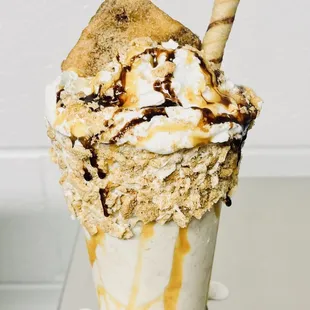 an ice cream sundae topped with whipped cream and caramel