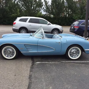 a blue sports car parked in a parking lot